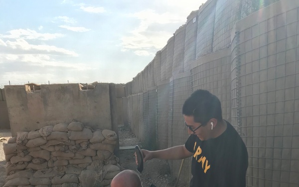 Field Barber gives Soldier haircut