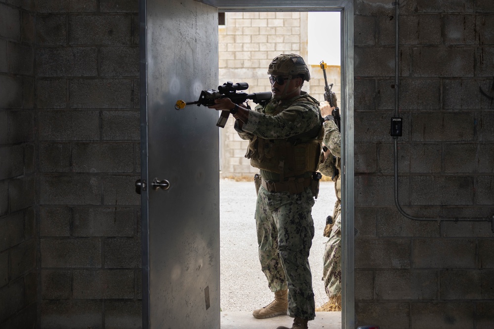 U.S. Navy Sailors and Marines perform Close Quarters Battle drills