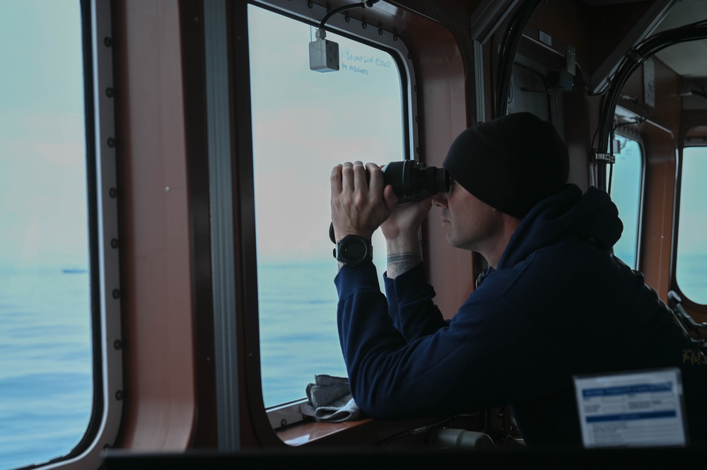 A Coast Guard Cutter Forest Rednour crew member stands watch off southwest border