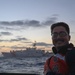 A Coast Guard Cutter Forrest Rednour crew member stands for a photo during fast-rope training