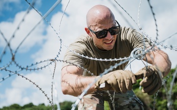 346th AEW lay concertina wire