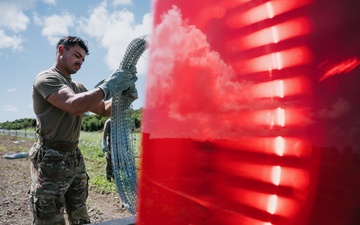 346th AEW lay concertina wire