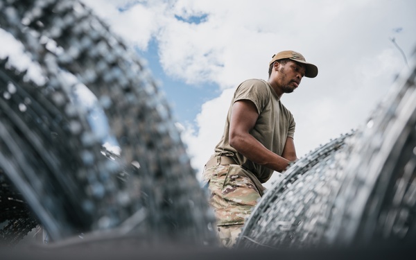 346th AEW lay concertina wire