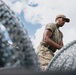346th AEW lay concertina wire