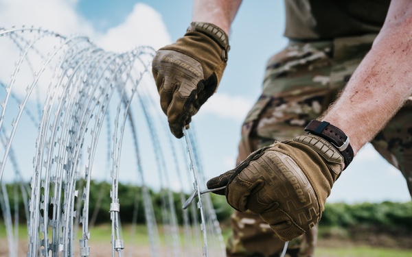 346th AEW lay concertina wire