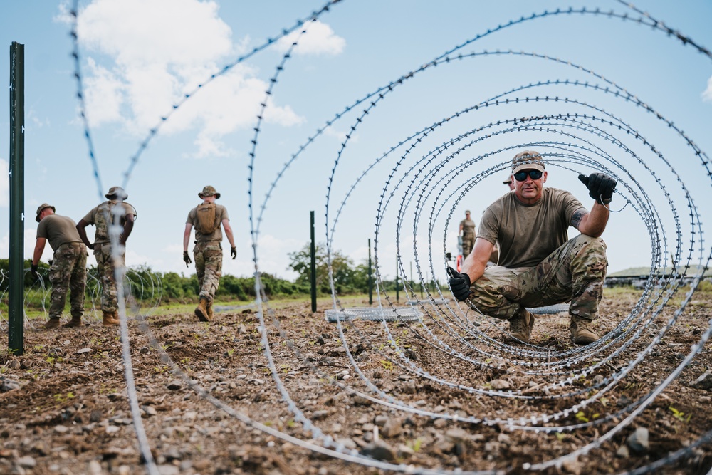 346th AEW lay concertina wire