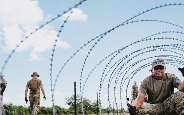 346th AEW lay concertina wire