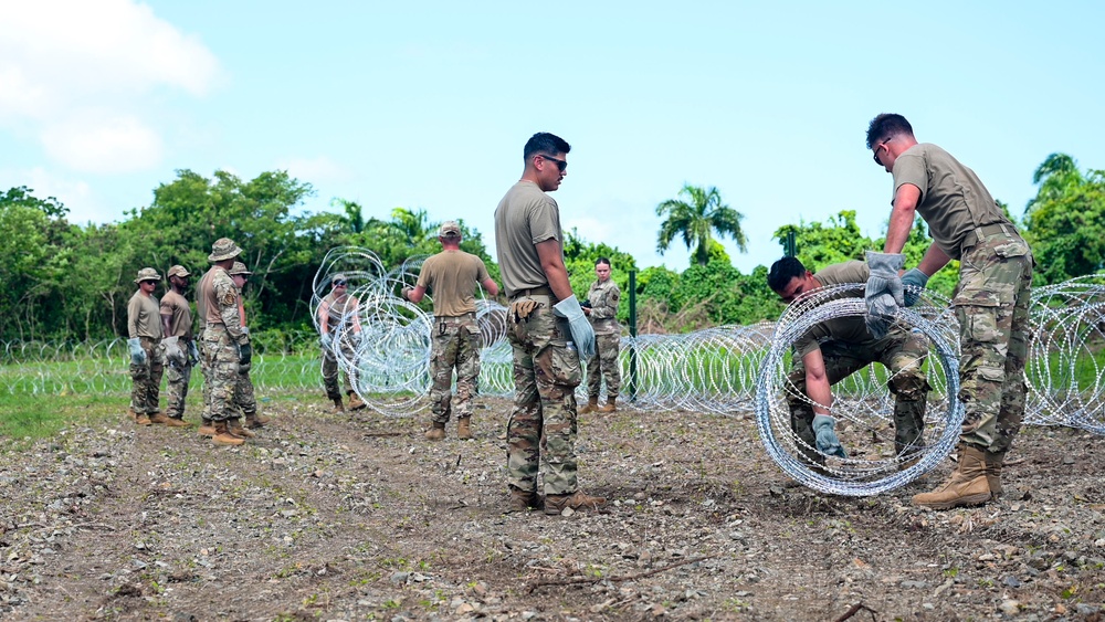 346th AEW lay concertina wire