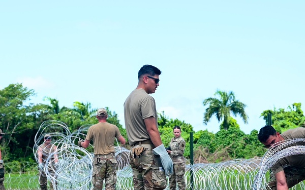 346th AEW lay concertina wire