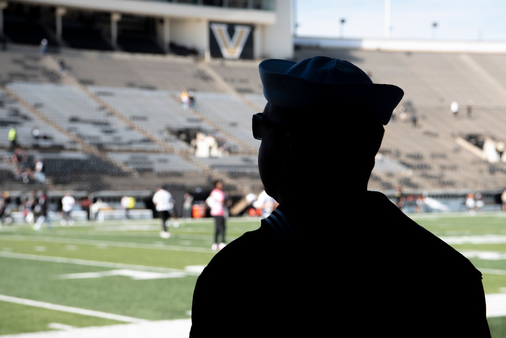 Navy Recruiter Looks across Field Navy Recruiter Looks across Field