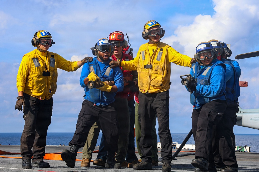 USS Iwo Jima Sailors and U.S. Marines Conduct An Aviation Training Team Drill on the Flight Deck