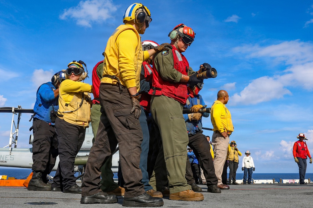 USS Iwo Jima Sailors and U.S. Marines Conduct An Aviation Training Team Drill on the Flight Deck
