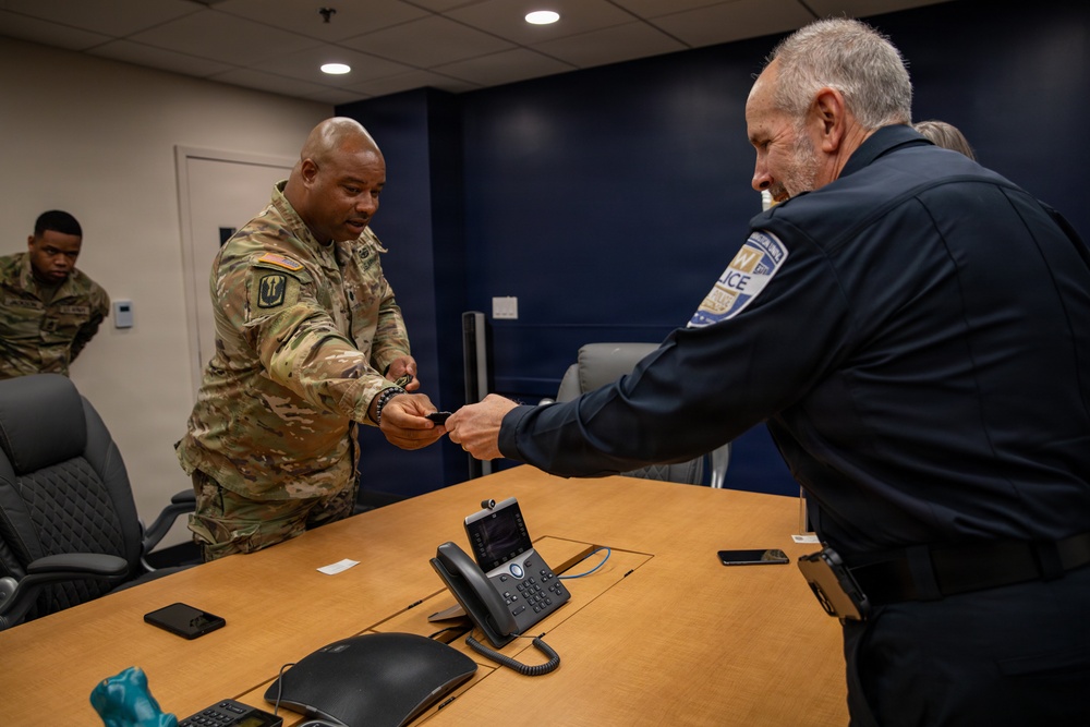 Lt. Col. Steven Jackson, MSNG, gives a unit patch to George Washington University Police Chief, Victor Brito