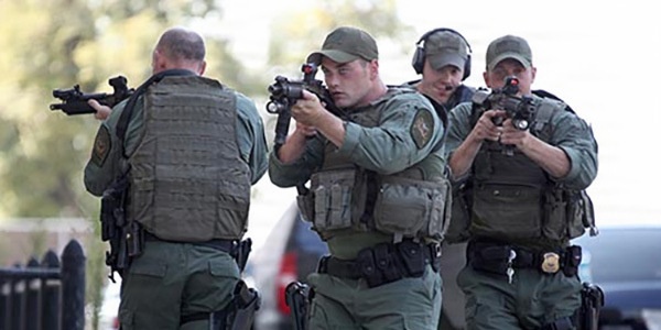 Emergency Response Team members on alert with guns drawn