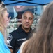A Pentagon police officer talks with a job seekers at a job fair
