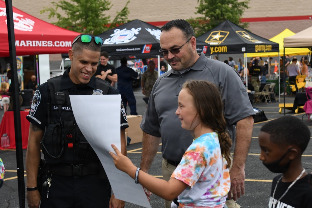 A Pentagon police officer talks with a job seeker at a job fair