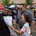 A Pentagon police officer talks with a job seeker at a job fair