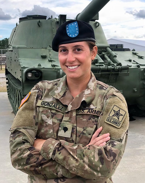 Veteran standing in front of a tank