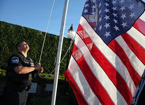 A Pentagon police officer raises the flag