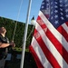 A Pentagon police officer raises the flag