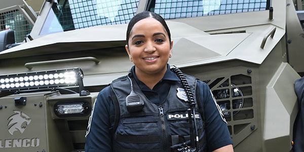 A Pentagon police officer poses in front of an armored vehicle