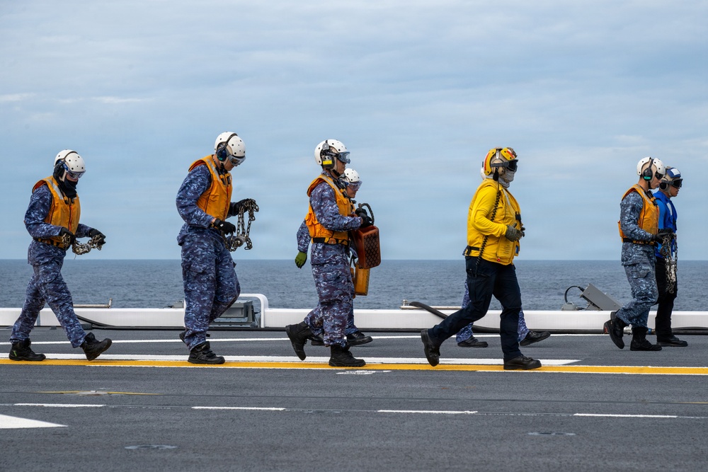 U.S. Sailors and JMSDF members conduct flight operations aboard the JS Kaga