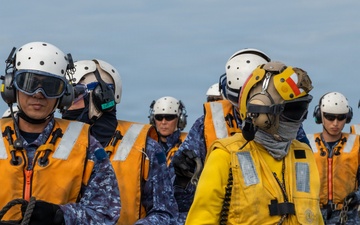 U.S. Sailors and JMSDF members conduct flight operations aboard the JS Kaga