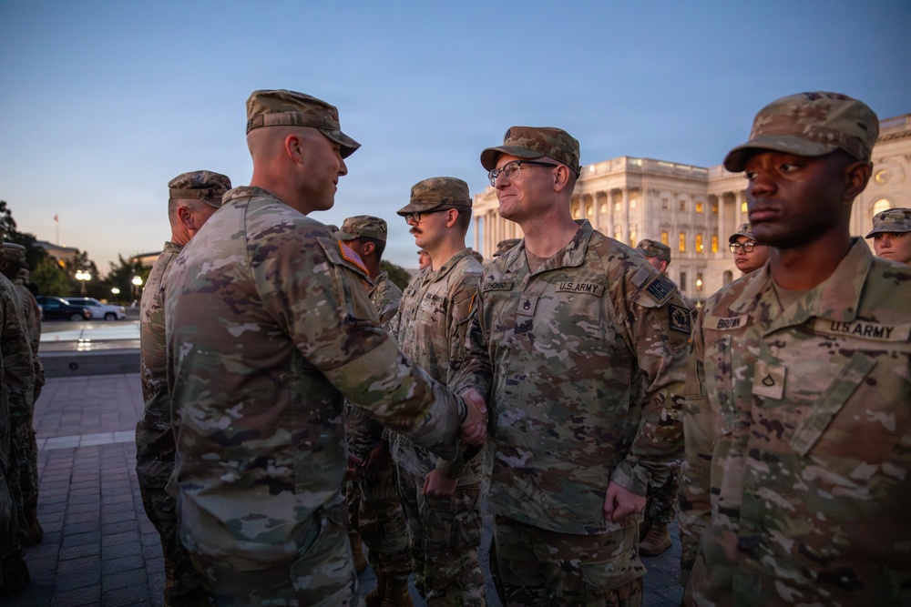 Mississippi National Guard service members receive coins during a promotion ceremony in front of the U.S. Capitol