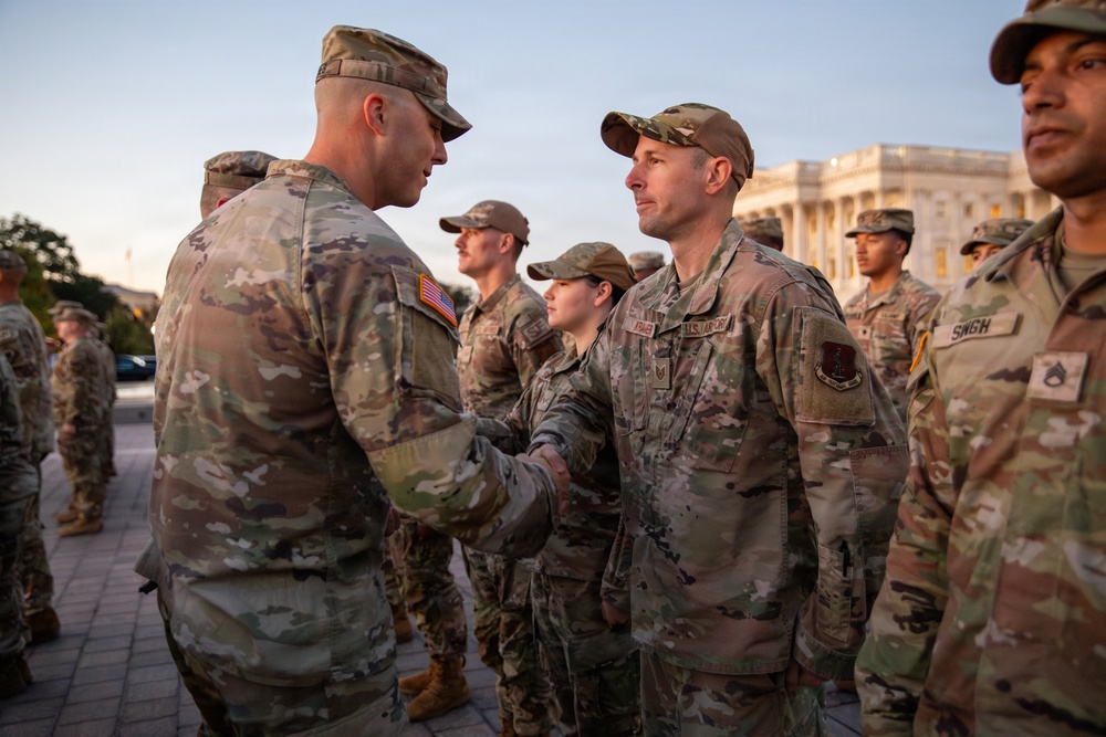 Mississippi National Guard service members receive coins during a promotion ceremony in front of the U.S. Capitol