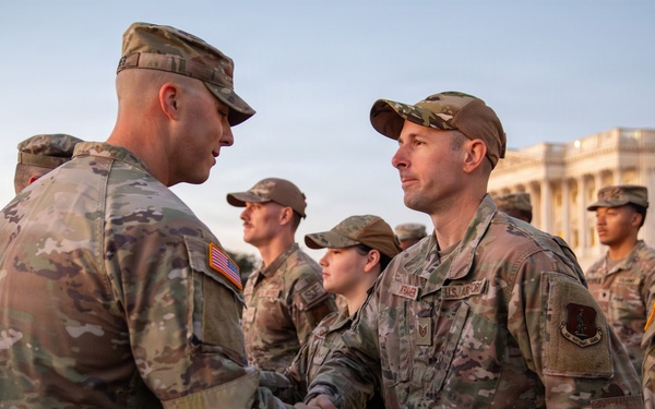 Mississippi National Guard service members receive coins during a promotion ceremony in front of the U.S. Capitol