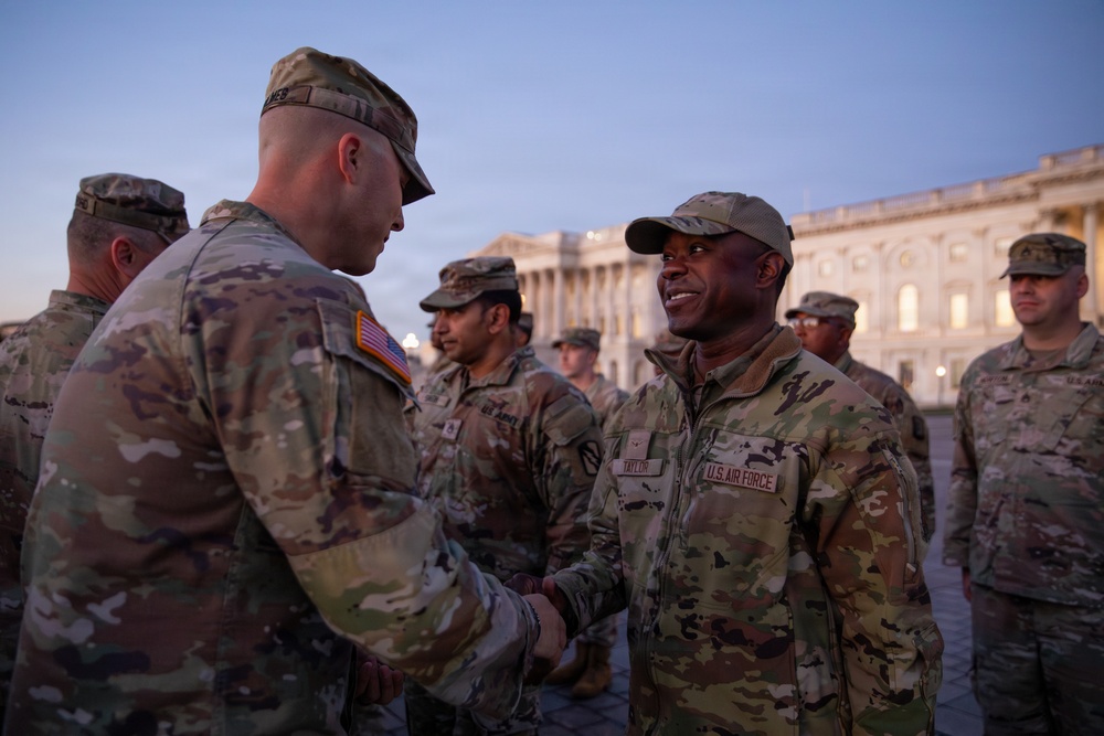 Mississippi National Guard service members receive coins during a promotion ceremony in front of the U.S. Capitol