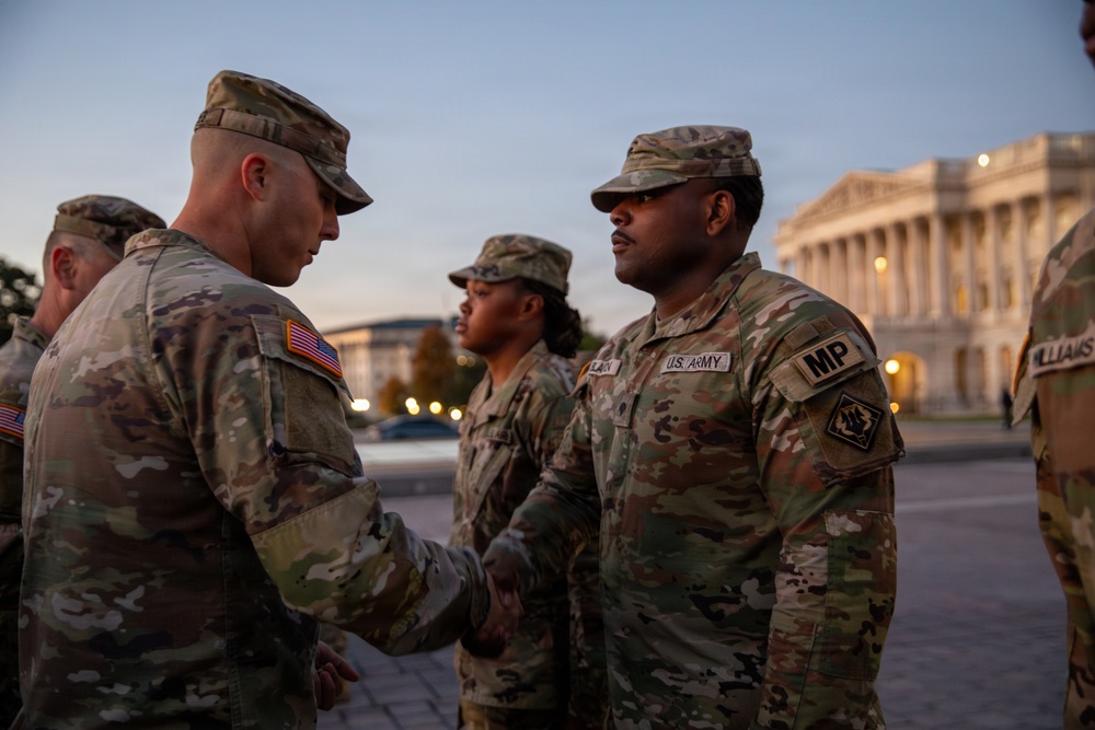 Mississippi National Guard service members receive coins during a promotion ceremony in front of the U.S. Capitol
