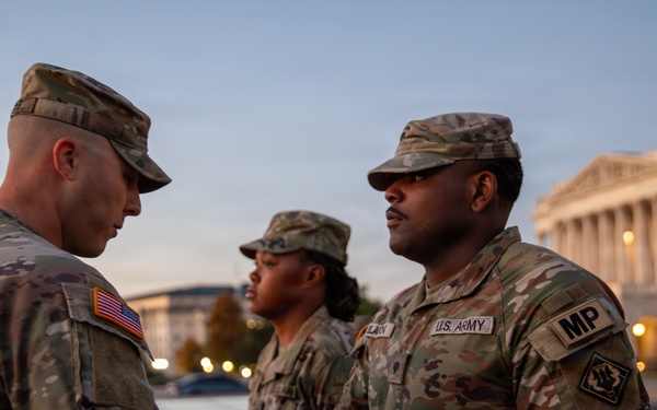 Mississippi National Guard service members receive coins during a promotion ceremony in front of the U.S. Capitol
