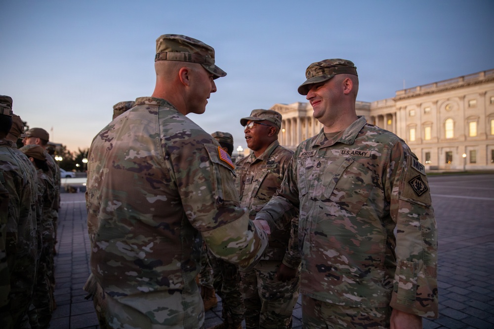 Mississippi National Guard service members receive coins during a promotion ceremony in front of the U.S. Capitol