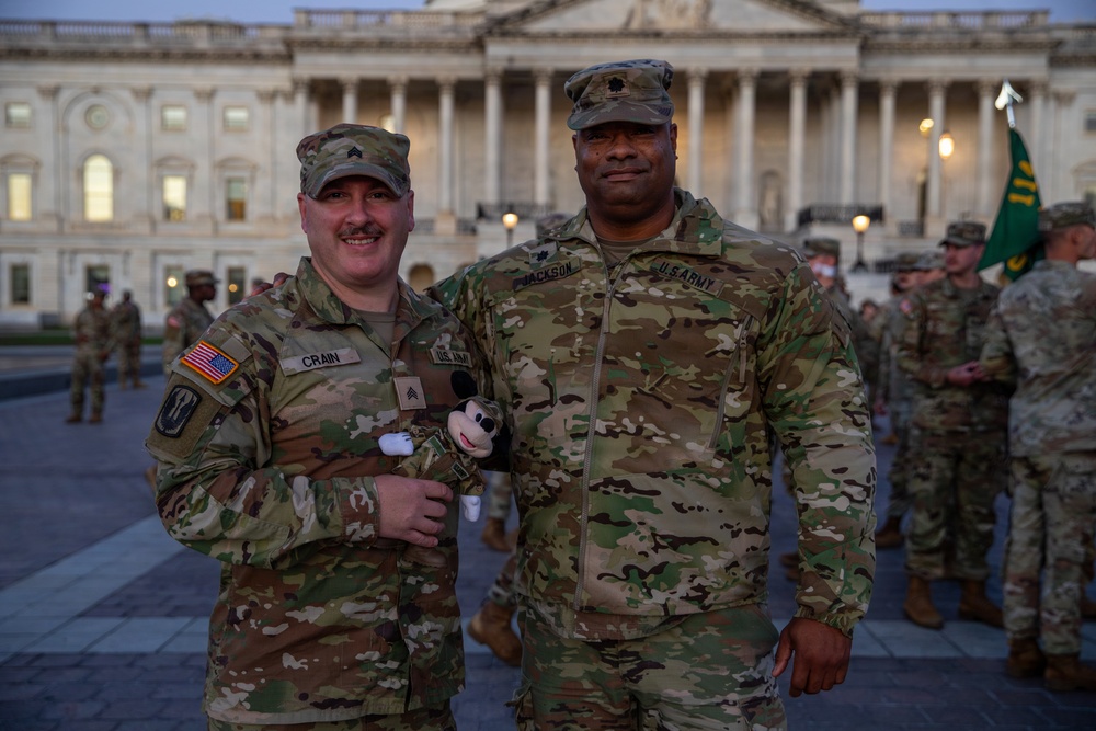 Lt. Col. Steven Jackson takes a picture with a Soldier in front of the U.S. Capitol