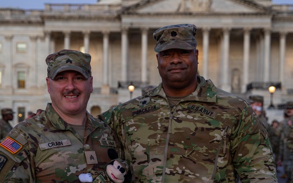 Lt. Col. Steven Jackson takes a picture with a Soldier in front of the U.S. Capitol