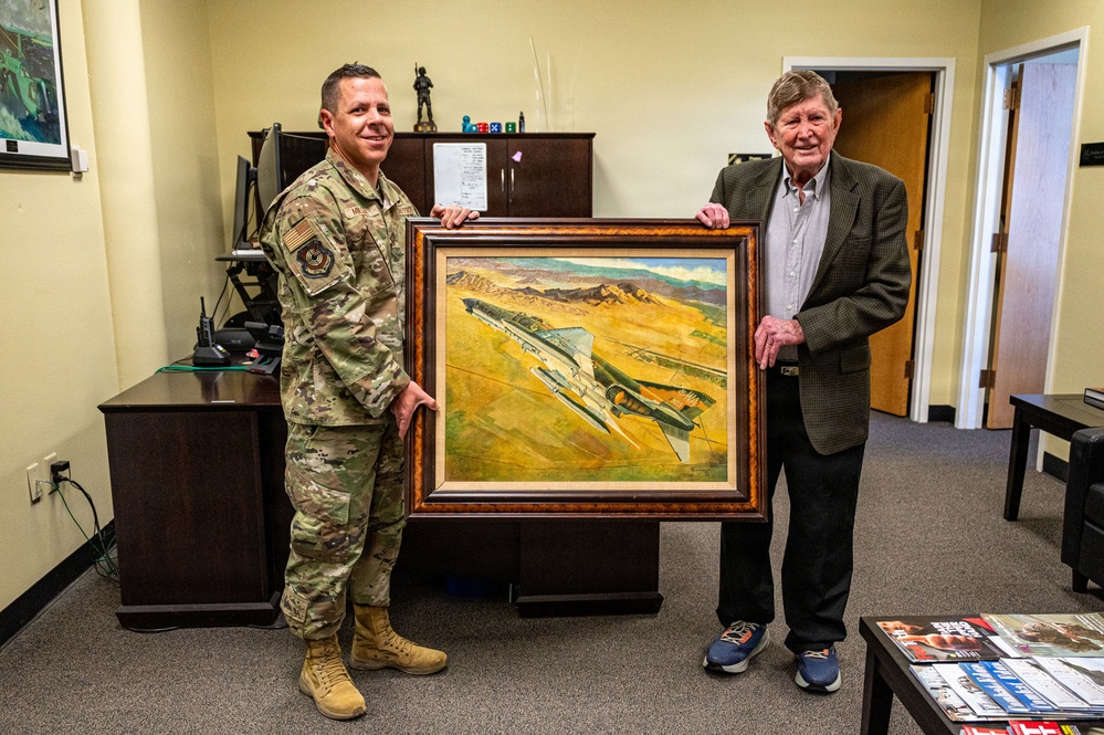 Retired Weapons School officer donates painting of former Chief of Staff piloting F-4 Phantom II to 57th Wing