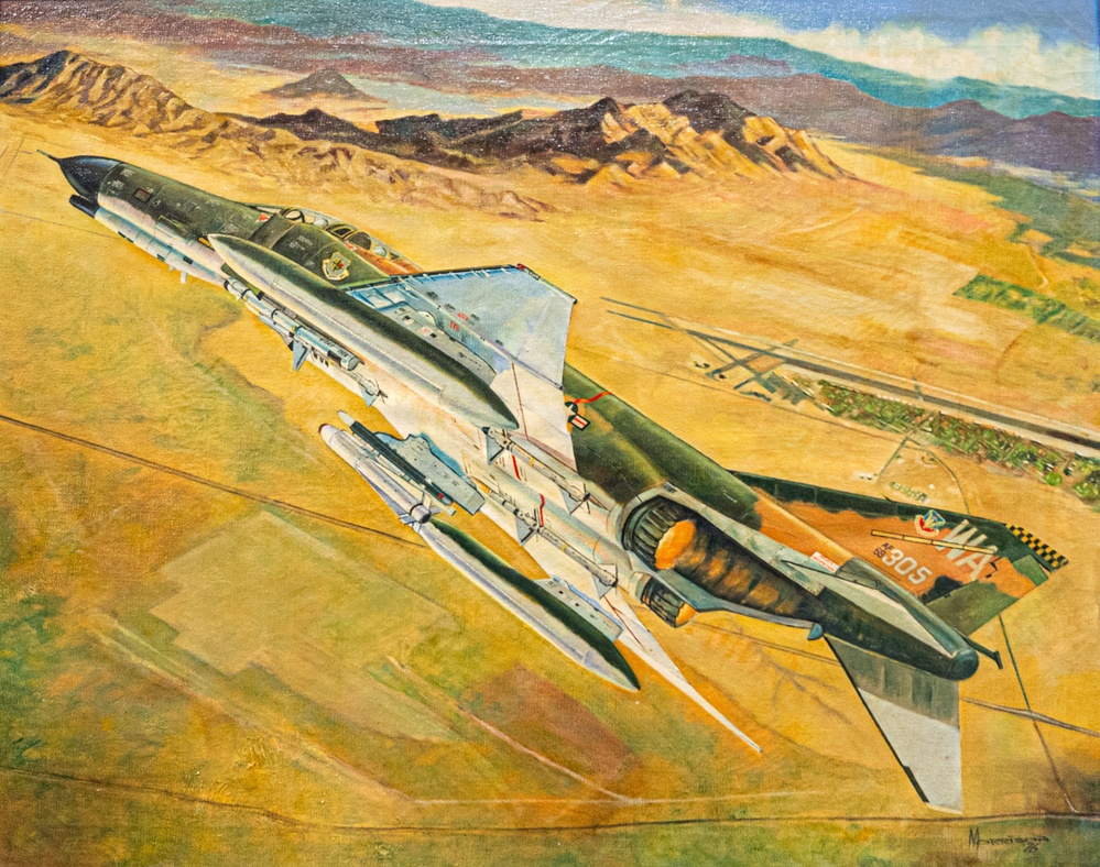 Retired Weapons School officer donates painting of former Chief of Staff piloting F-4 Phantom II to 57th Wing