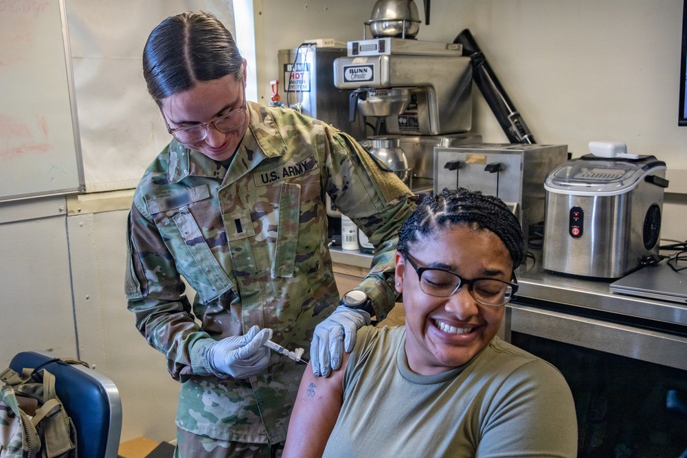 Combat medic specialist administers flu vaccinations