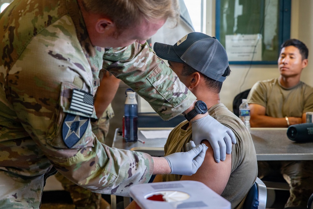 Combat medic specialist administers flu vaccinations