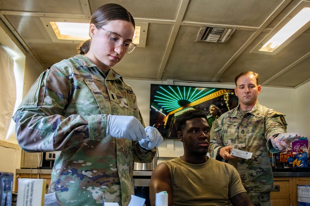 Combat medic specialist administers flu vaccinations