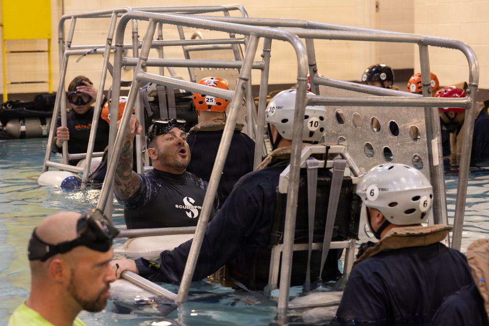 U.S. Marines with MWCS-28 dive into Underwater Egress Training