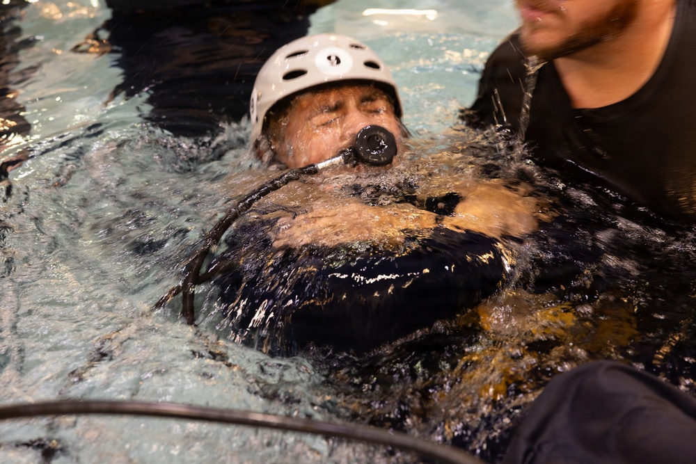 U.S. Marines with MWCS-28 dive into Underwater Egress Training