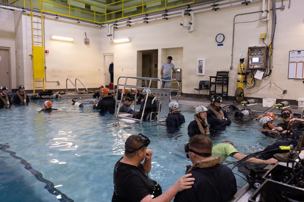 U.S. Marines with MWCS-28 dive into Underwater Egress Training