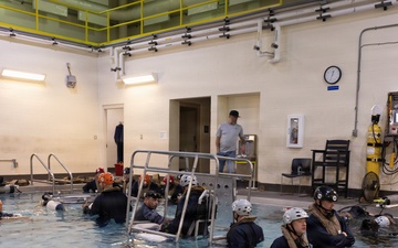 U.S. Marines with MWCS-28 dive into Underwater Egress Training