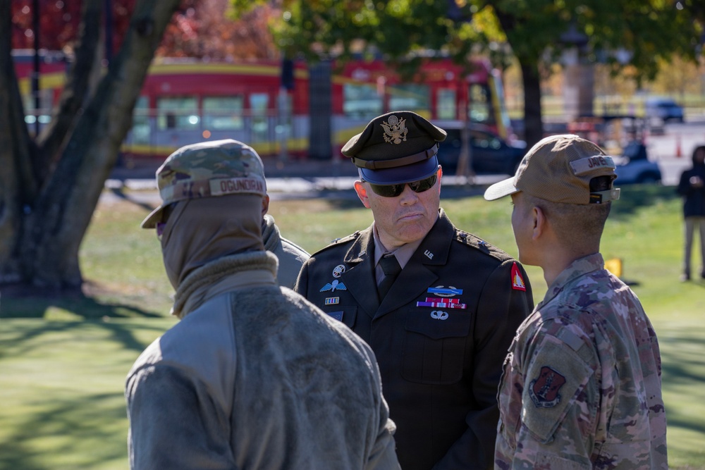 Brig. Gen. Leland D. Blanchard II speak with airmen at local golf course