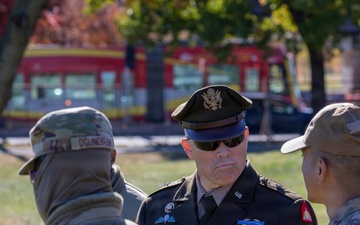 Brig. Gen. Leland D. Blanchard II speak with airmen at local golf course