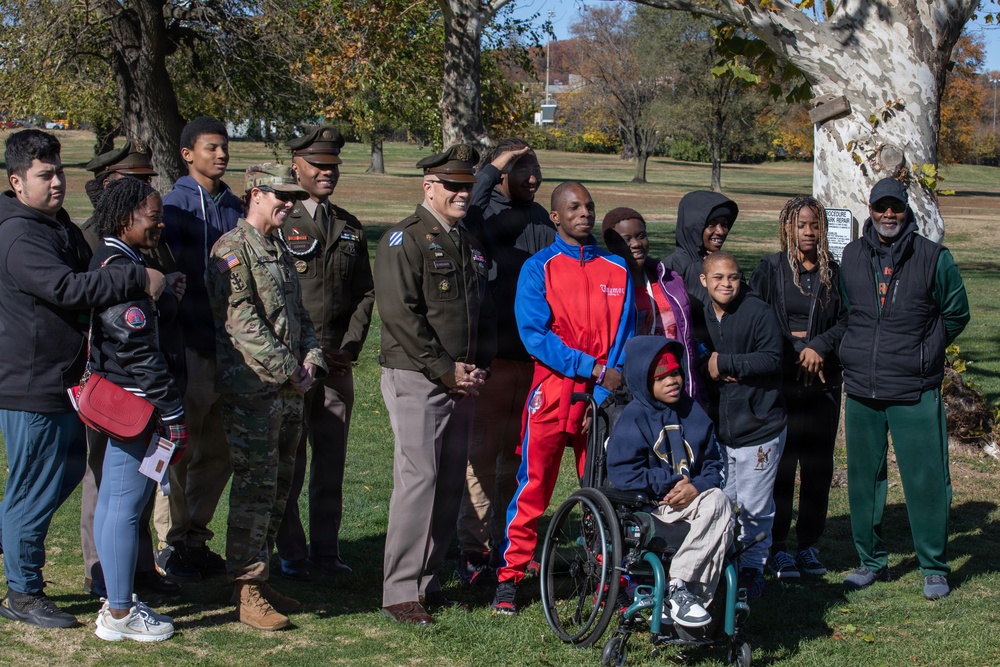 Soldiers pose for photo with children participating in Special Olympics program