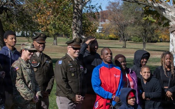 Soldiers pose for photo with children participating in Special Olympics program