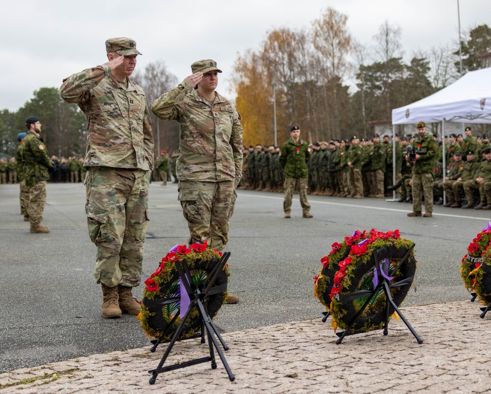 U.S. Army Soldiers lay a wreath down next to other NATO countries’ wreaths